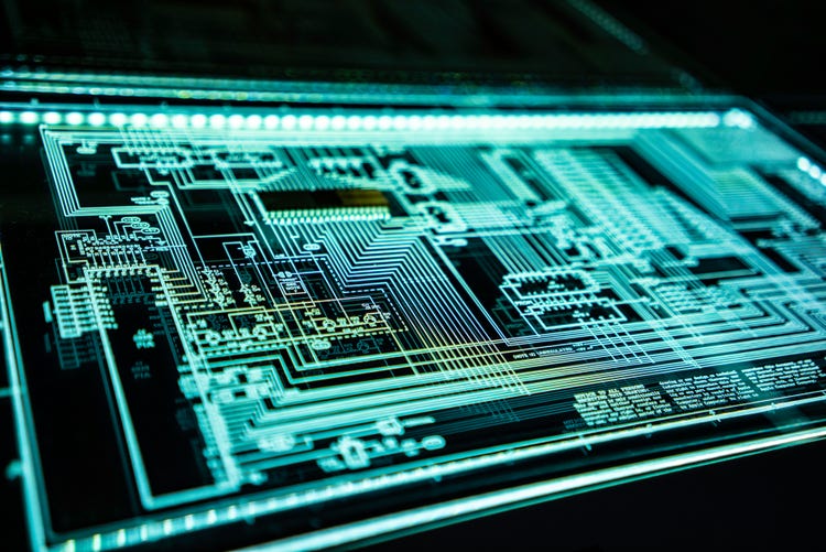 A close-up, high-angle shot of a glowing blue-green circuit board, showcasing intricate patterns of illuminated lines and components on a dark background, Technical Panel